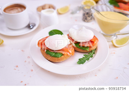 Cream cheese, Smoked salmon and poached egg toasts on a plate Cream cheese, Smoked salmon and poached egg toasts on a plate 93918734