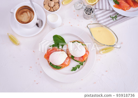Cream cheese, Smoked salmon and poached egg toasts on a plate Cream cheese, Smoked salmon and poached egg toasts on a plate 93918736