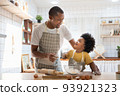 African American Father and son playing in kitchen 93921323
