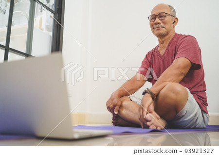 Asian senior man looking while exercises Asian senior man looking while exercises 93921327
