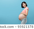 Korean pregnant woman standing on Blue background 93921378