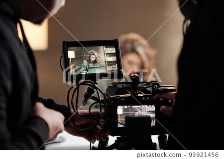 Close-up of steadicam screens with female model using laptop by table 93921456