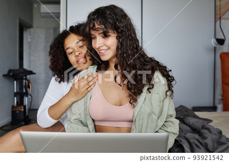 Young affectionate African American woman embracing her girlfriend 93921542
