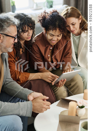 Mature couple and girlfriends looking through online collection of wedding gowns Mature couple and girlfriends looking through online collection of wedding gowns 93921588