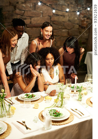 Happy young newlyweds and their guests communicating in video chat Happy young newlyweds and their guests communicating in video chat 93921639