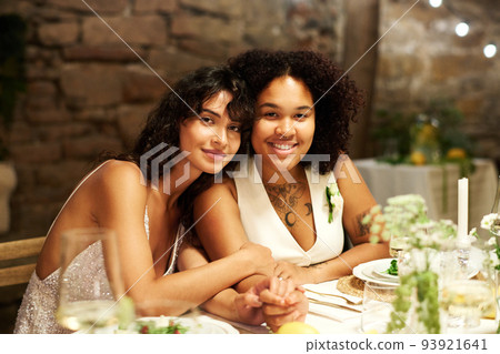 Happy young intercultural homosexual couple in white wedding apparel 93921641