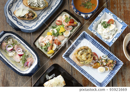 selection of many different tapas on rustic wood table 93921669