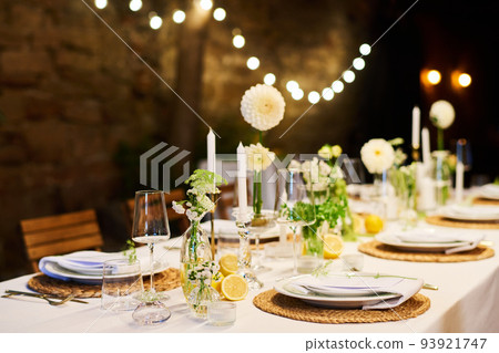 Festive table with two rows of plates with napkins prepared for wedding feast 93921747