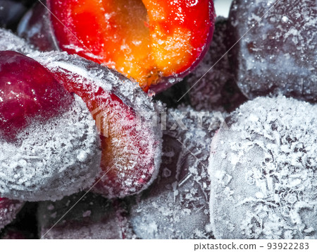 Selective focus on white ice crystals on frozen plum Selective focus on white ice crystals on frozen plum 93922283