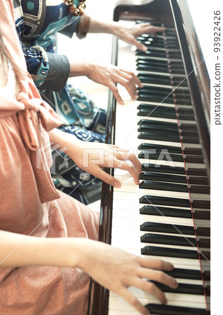 Woman and teacher playing the piano 93922426