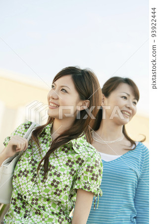 Mother and daughter looking far away 93922444