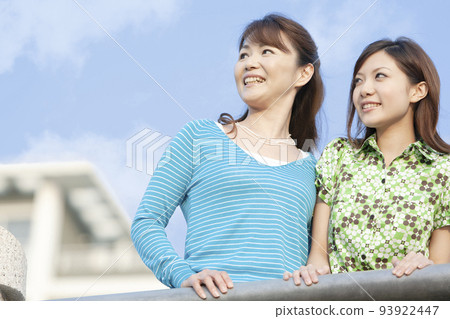 Mother and daughter looking far away 93922447