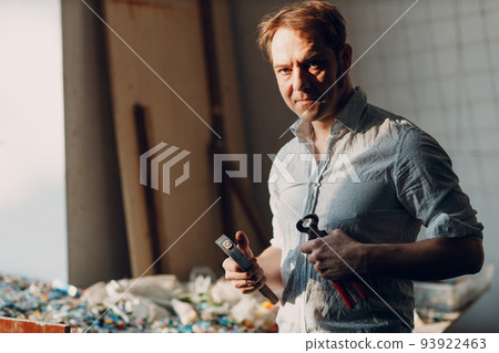 Craftsman male master portrait hold hammer and smalt glass pieces in arm hand for mosaic artwork in workshop. Craftsman male master portrait hold hammer and smalt glass pieces in arm hand for mosaic artwork in workshop. 93922463