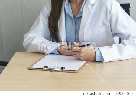 Close up hands of women doctor write prescription medical lab hospital. Crop asian women hand doctors working in medical clinic looking CAT scan xray film. Doctor with stethoscope writing on notepad Close up hands of women doctor write prescription medical lab hospital. Crop asian women hand doctors working in medical clinic looking CAT scan xray film. Doctor with stethoscope writing on notepad 93924166
