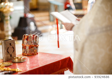 Church wedding crowns at the table with cross and glass of vine 93924686