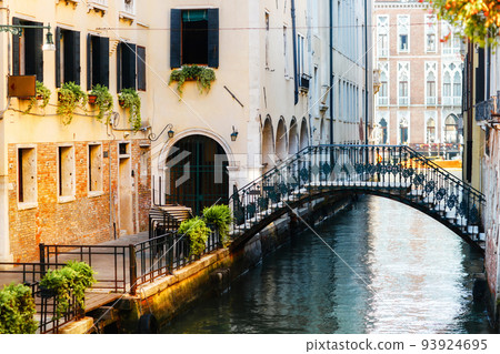 Canal in Venice and colorful buildings with a pedestrian bridge Canal in Venice and colorful buildings with a pedestrian bridge 93924695