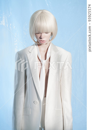 Studio fashion photo of young elegant woman in white men's jacket Studio fashion photo of young elegant woman in white men's jacket 93925574