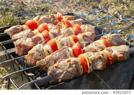 Barbecue Grilled pork kebabs meat, pieces of meat on skewers. process of cooking marinated meat on fire. Barbecue Grilled pork kebabs meat, pieces of meat on skewers. process of cooking marinated meat on fire. 93925873