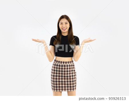 Asian woman in black crop t-shirt posing hand pointing on white background. 93926313