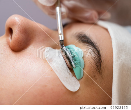 Close-up portrait of a woman on eyelash lamination procedure. Close-up portrait of a woman on eyelash lamination procedure. 93928155