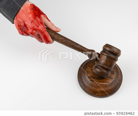 Female judge with bloody hands beats the gavel on a white background. 93928462