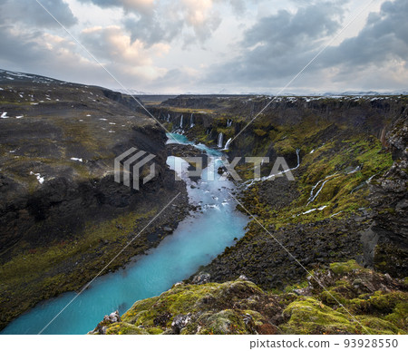 Autumn snowfall on picturesque waterfall Sigoldugljufur  view. Season changing in southern Highlands of Iceland. 93928550