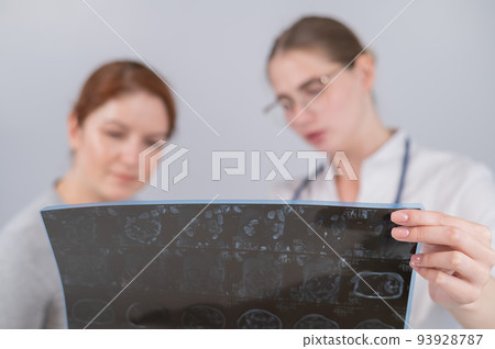 Female doctor explaining mri of internal organs to female patient.  93928787