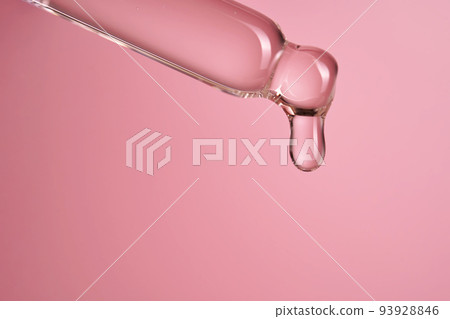 Dropper with serum or cosmetic oil on a pink background. Dropper with serum or cosmetic oil on a pink background. 93928846