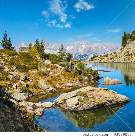 Calm autumn Alps mountain lake with clear transparent water and reflections. Spiegelsee or Mirror Lake, Reiteralm, Steiermark, Austria. 93929092