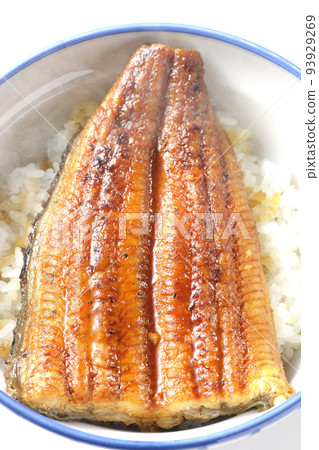 A bird's-eye view of a hot eel bowl with grilled eel on top of white rice against a white background A bird's-eye view of a hot eel bowl with grilled eel on top of white rice against a white background 93929269