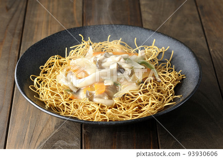 A hot dish of udon noodles topped with bean paste containing shimeji mushrooms, carrots, and onions. A hot dish of udon noodles topped with bean paste containing shimeji mushrooms, carrots, and onions. 93930606