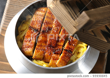 A bird's-eye view of a hot pot rice with grilled eel on a black background A bird's-eye view of a hot pot rice with grilled eel on a black background 93930845