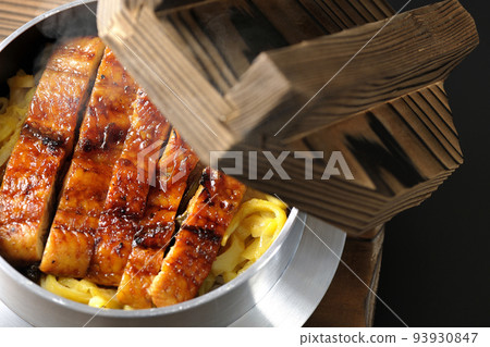 A bird's-eye view of a hot pot rice with grilled eel on a black background A bird's-eye view of a hot pot rice with grilled eel on a black background 93930847