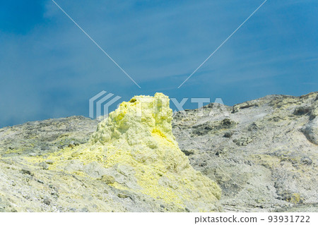 sulfur deposits around a solfatara in a fumarole field against a blue sky sulfur deposits around a solfatara in a fumarole field against a blue sky 93931722