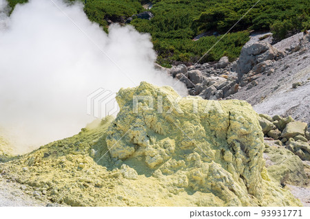 smoking solfatara in a fumarole field on the slope of the Mendeleev volcano 93931771
