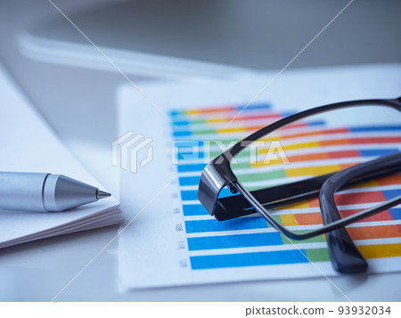 Business image of graphs, glasses, documents Business image of graphs, glasses, documents 93932034