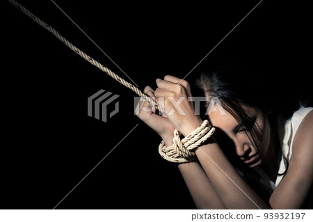 Asian Woman was capture in dark room as slavery. Human Trafficking is international crime that abuse violence victim illegal. They captive for trade sexual labor without human right help, copy space Asian Woman was capture in dark room as slavery. Human Trafficking is international crime that abuse violence victim illegal. They captive for trade sexual labor without human right help, copy space 93932197