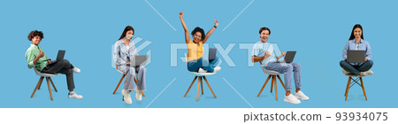 Glad young international people sit on chairs with laptop, rejoice online victory and celebrate success 93934075