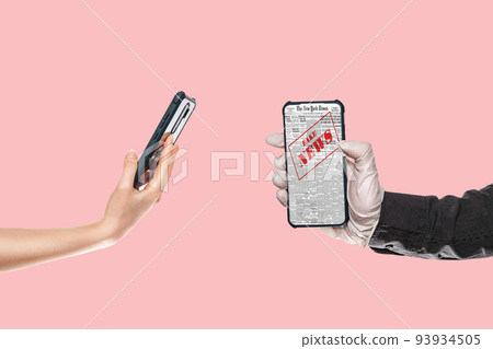 A man in medical gloves holds a smartphone with fake news.On the left, a woman's hand substitutes a smartphone.Pink background.The concept of disinformation and false news on the Internet 93934505