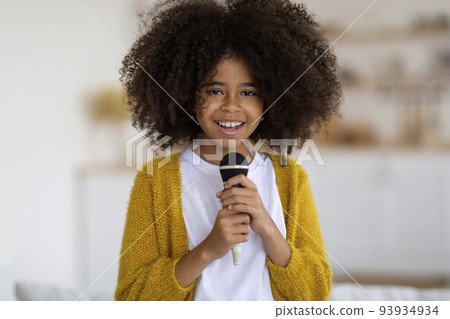 Adorable african american preteen girl holding microphone 93934934