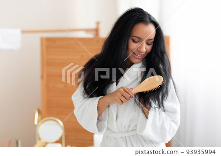 Lady Brushing Long Brunette Hair With Wooden Brush In Bathroom Lady Brushing Long Brunette Hair With Wooden Brush In Bathroom 93935994