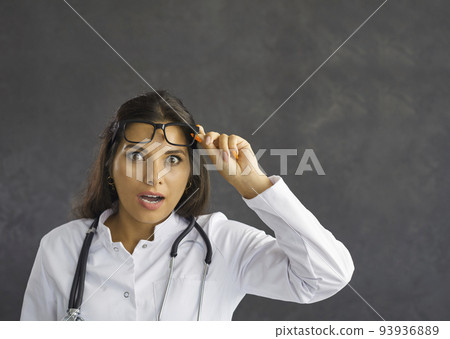 Portrait of amazed woman doctor feel shocked 93936889