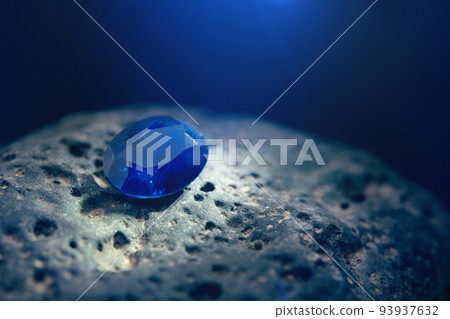 Blue Sapphire Gemstone on Natural Stone 93937632