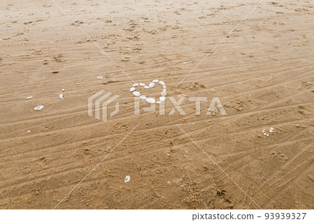 Heart made of sea shells at the sea beach. Holiday love concept 93939327