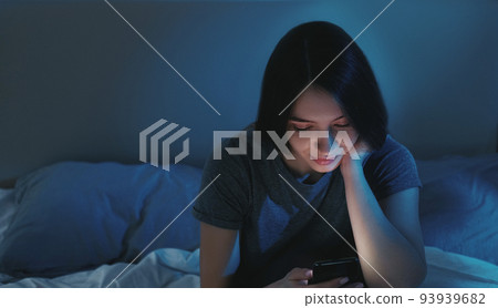 Vertical video. Digital life. Insomnia woman. Sleepless night. Bored relaxed lady scrolling smartphone in bed light shadow home interior. Vertical video. Digital life. Insomnia woman. Sleepless night. Bored relaxed lady scrolling smartphone in bed light shadow home interior. 93939682