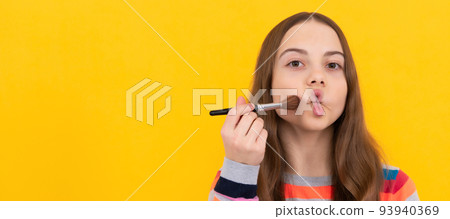 Funky beauty. Funny child apply makeup making fish lips. Makeup and visage. Childrens cosmetics. Cosmetics for teenager child, poster design. Beauty kids makeup, banner with copy space. Funky beauty. Funny child apply makeup making fish lips. Makeup and visage. Childrens cosmetics. Cosmetics for teenager child, poster design. Beauty kids makeup, banner with copy space. 93940369