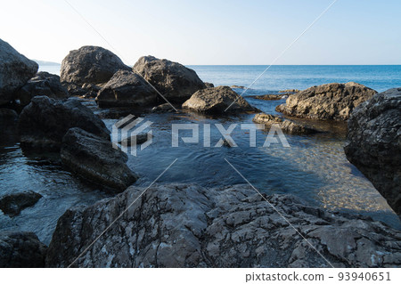 Rock formations on the background of the sea in the early morning. Clean water, ecosystem. The Crimean Laspi Reserve. Rock formations on the background of the sea in the early morning. Clean water, ecosystem. The Crimean Laspi Reserve. 93940651