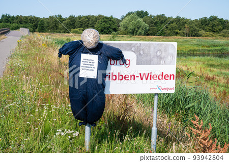 Emmeloord, Overijssel, The Netherlands - Puppet with farmer protest saying The Maffia government kiled our farmers with farmland in the background Emmeloord, Overijssel, The Netherlands - Puppet with farmer protest saying The Maffia government kiled our farmers with farmland in the background 93942804
