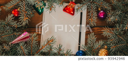 Christmas background with blank notebook for to-do list or wish list. with Christmas fir branches, decorations and gift boxes. Wooden rustic background for copy space photo banner Christmas background with blank notebook for to-do list or wish list. with Christmas fir branches, decorations and gift boxes. Wooden rustic background for copy space photo banner 93942946