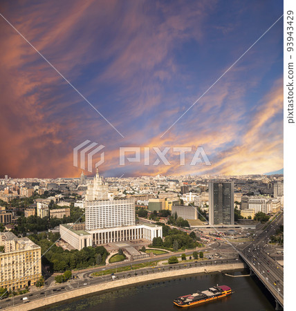 Aerial view of Moscow against the background of a romantic evening sky with clouds and rays of the sun. Government House of the Russian Federation (White House)-written in Russian, Russia Aerial view of Moscow against the background of a romantic evening sky with clouds and rays of the sun. Government House of the Russian Federation (White House)-written in Russian, Russia 93943429
